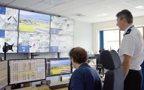 Ch Supt Carl Patrick, Cumbria Constabulary, with CCTV operator in front of a bank of CCTV screens