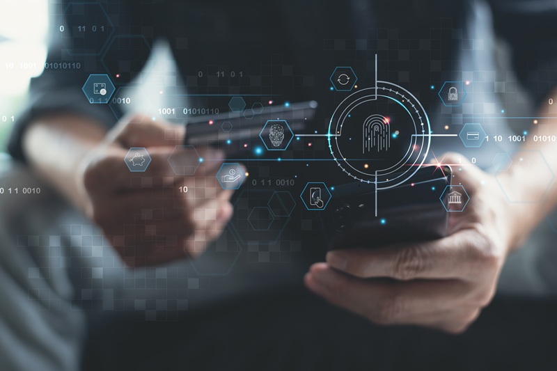 A person interacts with a smartphone displaying digital security icons and fingerprint imagery, emphasizing technology's role in modern policing and data management.