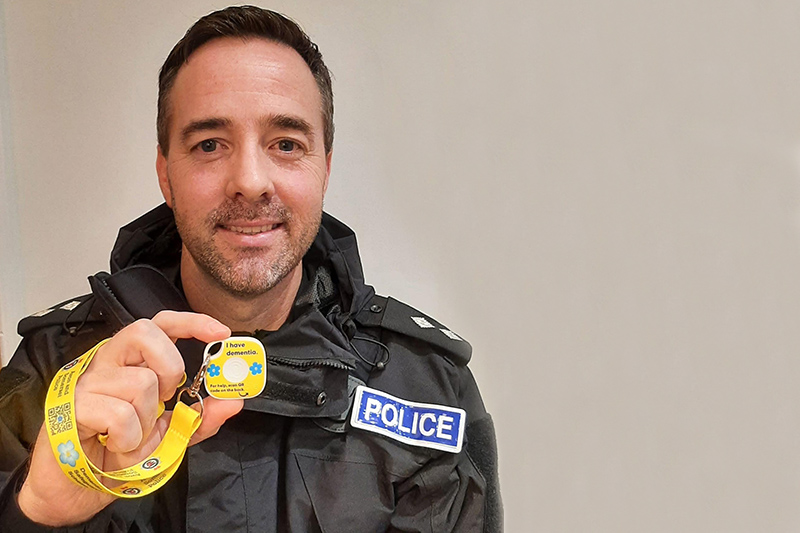 Avon & Somerset Police Inspector Stuart Kling holding up a dementia Bluetooth Tile tracker