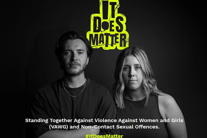 The image features a man and woman standing together, highlighting their commitment to combat violence against women and girls, emphasizing the slogan “It Does Matter” for awareness and action.