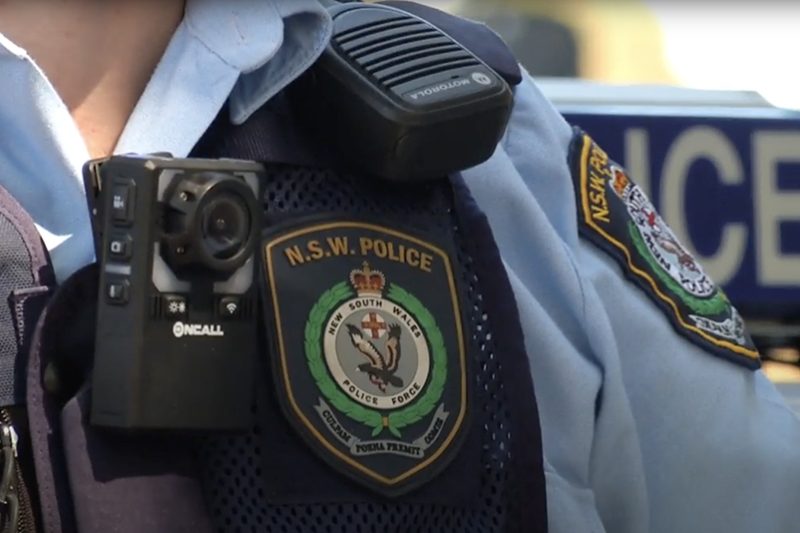 Close up of New South Wales Police Force badge and body-worn video camera