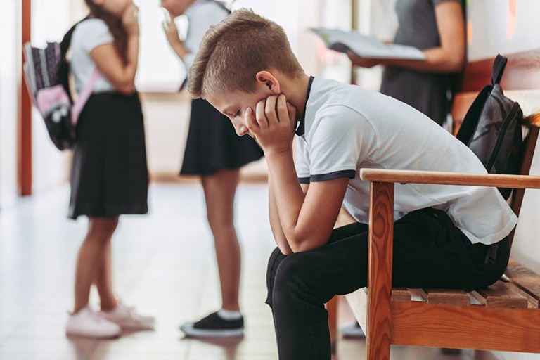 Child sitting on their own at school