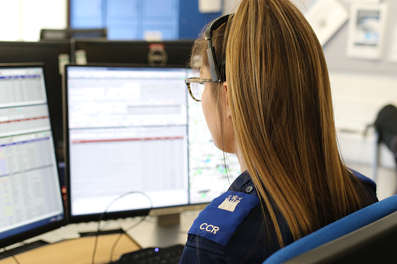 Picture of call handler (shot from behind) at a desk in Suffolk Police Control Room