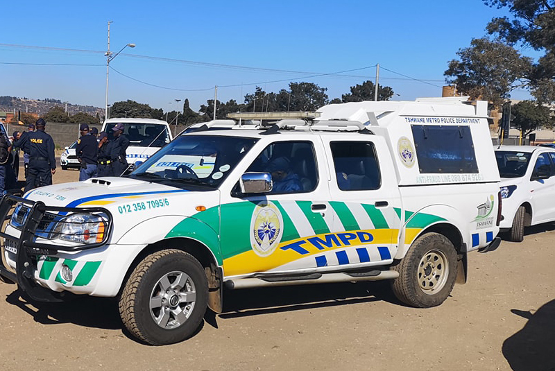 Tshwane Metro Police Dept vehicle with officers in the background