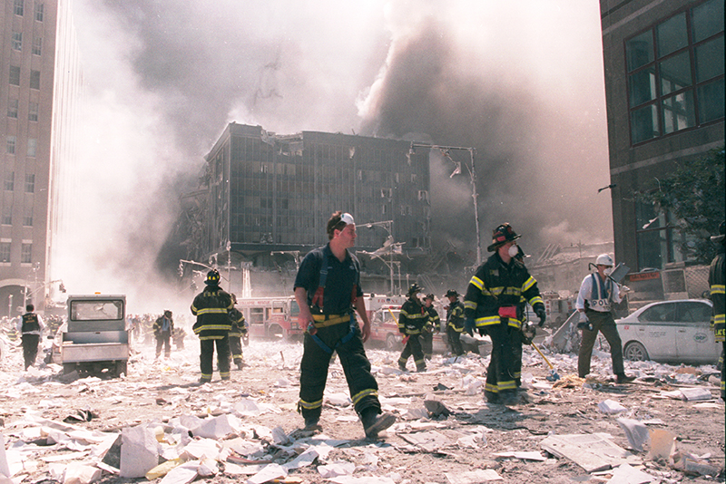 New York City firefighters work near the area known as Ground Zero after the collapse of the Twin Towers September 11, 2001 in New York City.