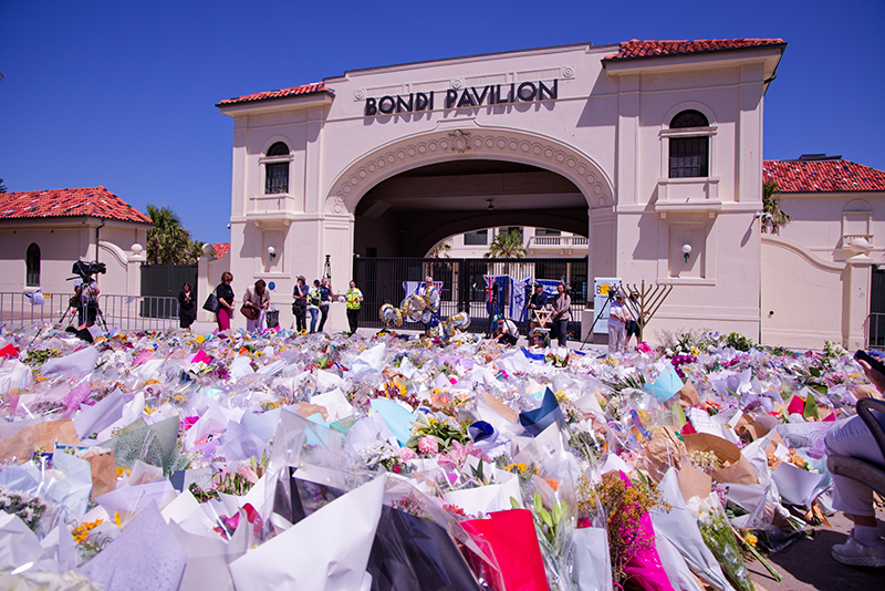 People gather at a flower memorial outside the Bondi Pavilion on December 17, 2025, in Sydney, Australia, following terrorist attack