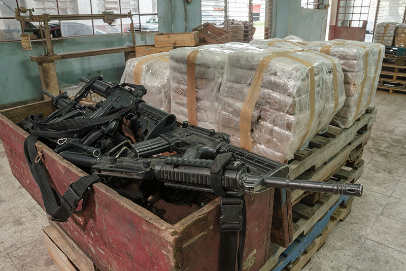 A cocaine warehouse with bales of drugs and firearms