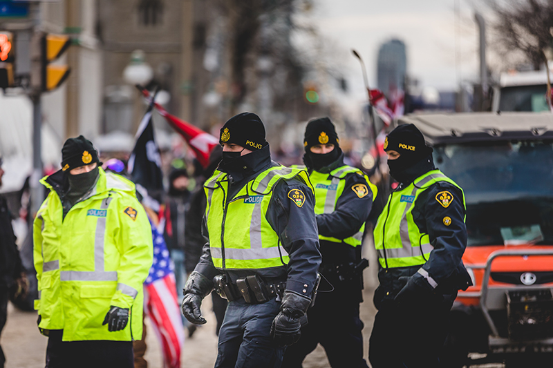 Ottawa, Ontario, Canada - January 30 2022. Police in Ottawa Convoy for Freedom 2022 and Protesters in the Streets.
