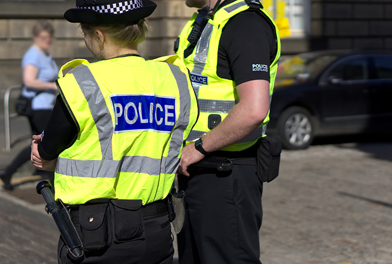 Police Scotland officers on duty on a city centre street during special event.