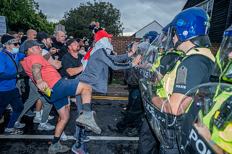 Far-right protestors attack a cordon of police