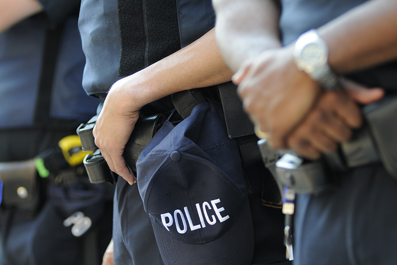 The hands of Toronto police officers as they stand in line with all weapons and armours during the G20 Protest on June 25, 2010 in Toronto, Canada.