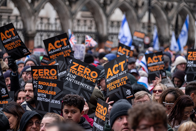 Crowds holding banners and flags aloft, at the March Against Antisemitism, held in central London during the Israel Gaza conflict