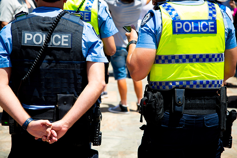 Rear view of two Western Australia Police officers patrolling Perth