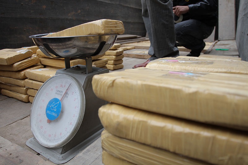 Seizure of drug or cocaine cargo in a truck with international destination. Packages filled with cocaine and the fight against drug trafficking.