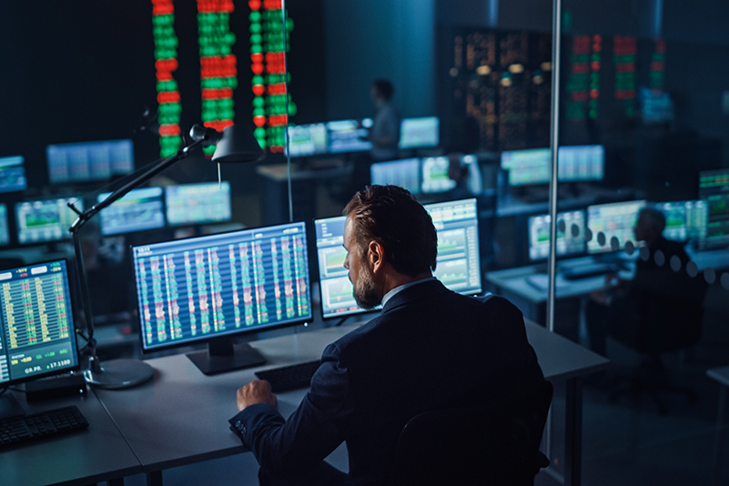 Data analysts working in a modern monitoring office with live feeds on screens, information sharing co-ordination