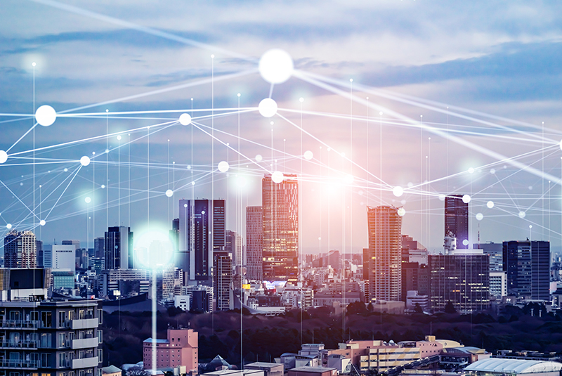 The image showcases a modern city skyline under a twilight sky, with interconnected lines and nodes representing data flow, highlighting advancements in technology relevant to policing and urban management.