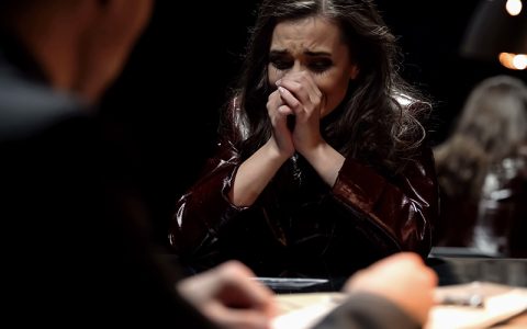 Woman crying, victim being questioned by a detective