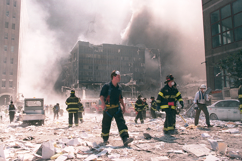 Firefighters work at Ground Zero following the collapse of the Twin Towers after the 9/11 attacks in New York