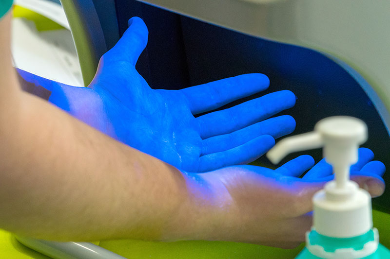 Hands under UV light forensics