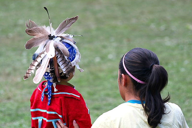 Young First Nations boy with mother, rear view