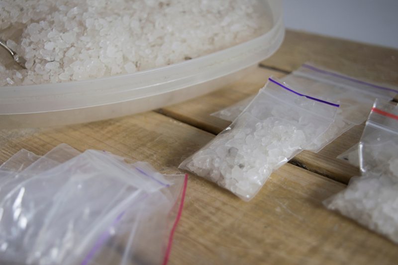 small bags and a plastic carton of flakka crystals, a methamphetamine