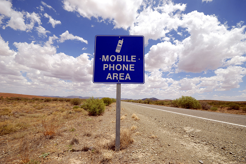 Sign in the Australian desert telling you that you can use the mobile phone in this area