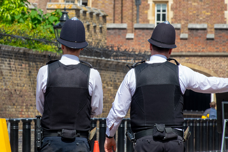 Picture of English policemen from behind in a street of London UK