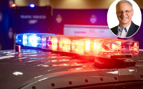 Blue and red police sirens on top of a patrol car with CCPE President Michael Federico inset