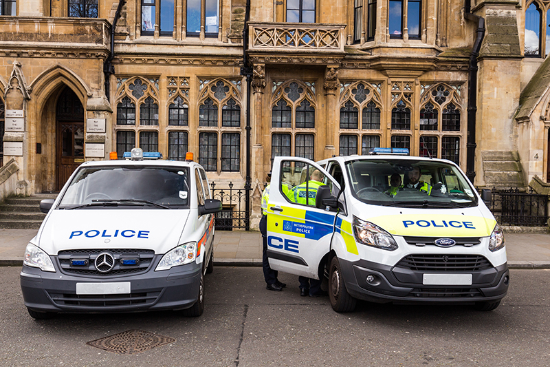 Two police vehicles on standby outside of St Margaret's Church in London, UK