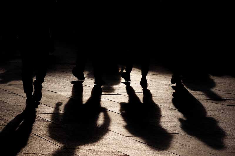 Black shadows and silhouettes of people on the street, concept of underworld gang or organised crime