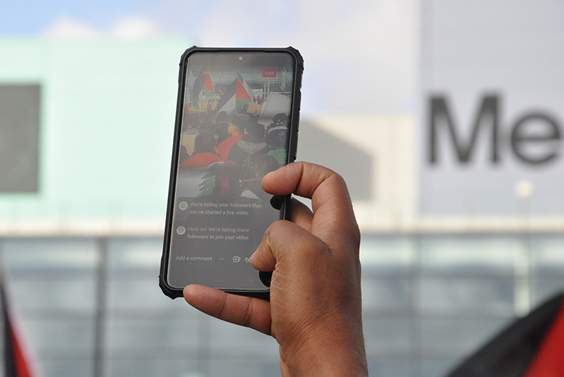 Close up of pro Palestinian protester's phone live streaming the rally to social media.
