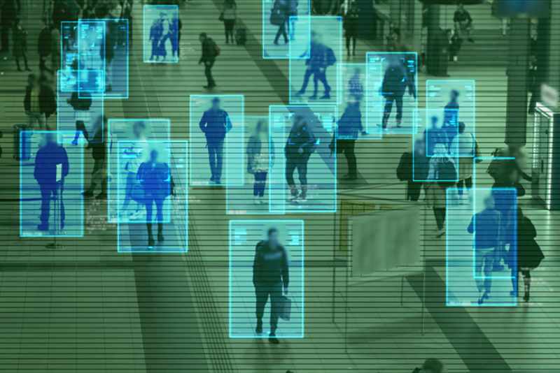 Scanning the crowd of people walking at the railway station.
