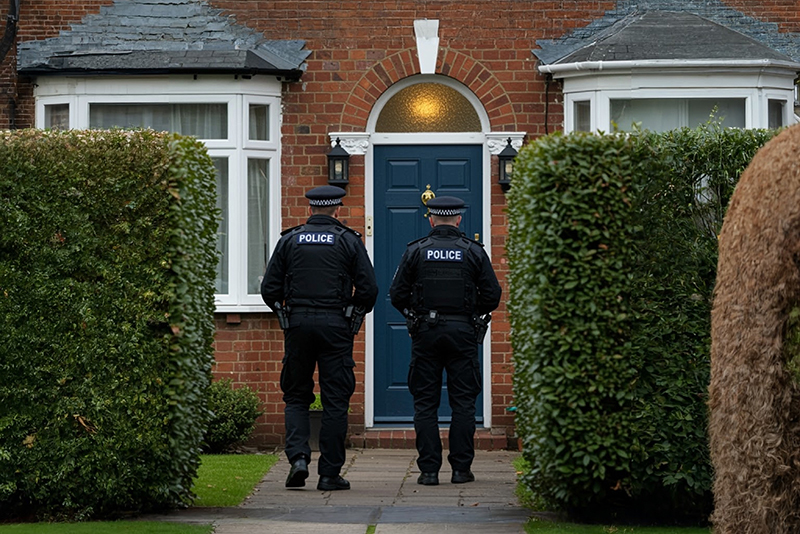 two officers arriving at a house to investigate crime domestic violence