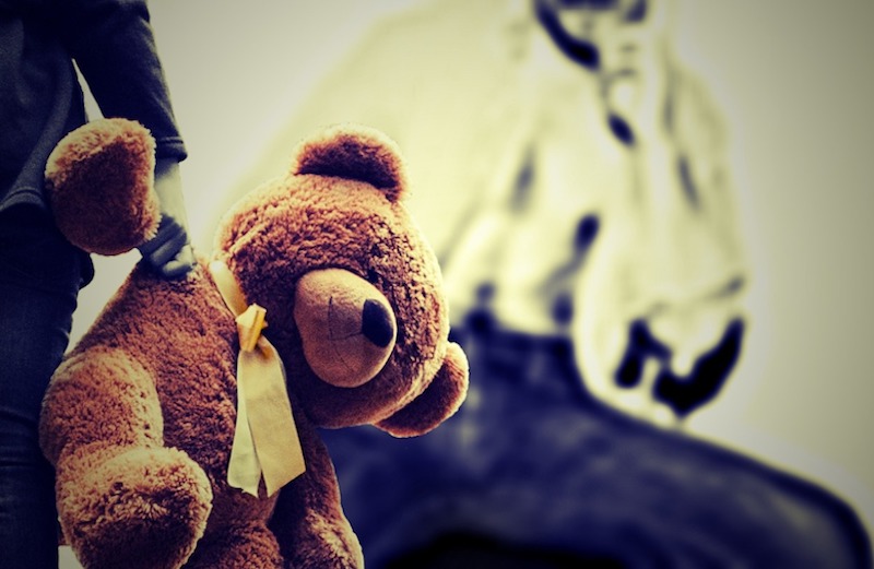 Picture of child carrying teddy representing child abuse