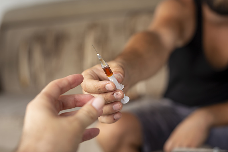 Intravenous drug users sharing syringe