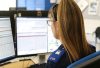 Picture of call handler (shot from behind) at a desk in Suffolk Police Control Room