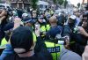 Cameras surrounding police officers at demonstration in London